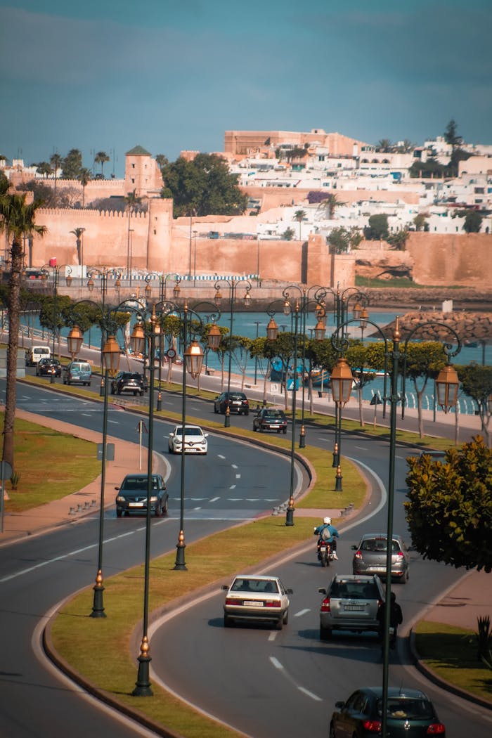 High angle view of a busy roadway with cars and historic architecture in the background.