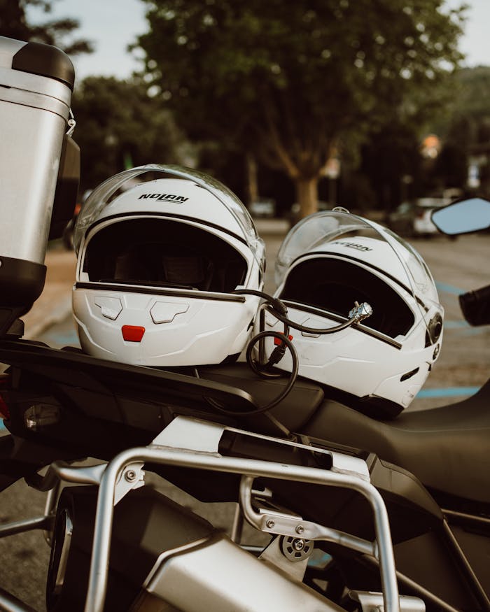 Close-up of motorcycle helmets on a bike in Stresa, Italy, perfect for travel and transportation imagery.